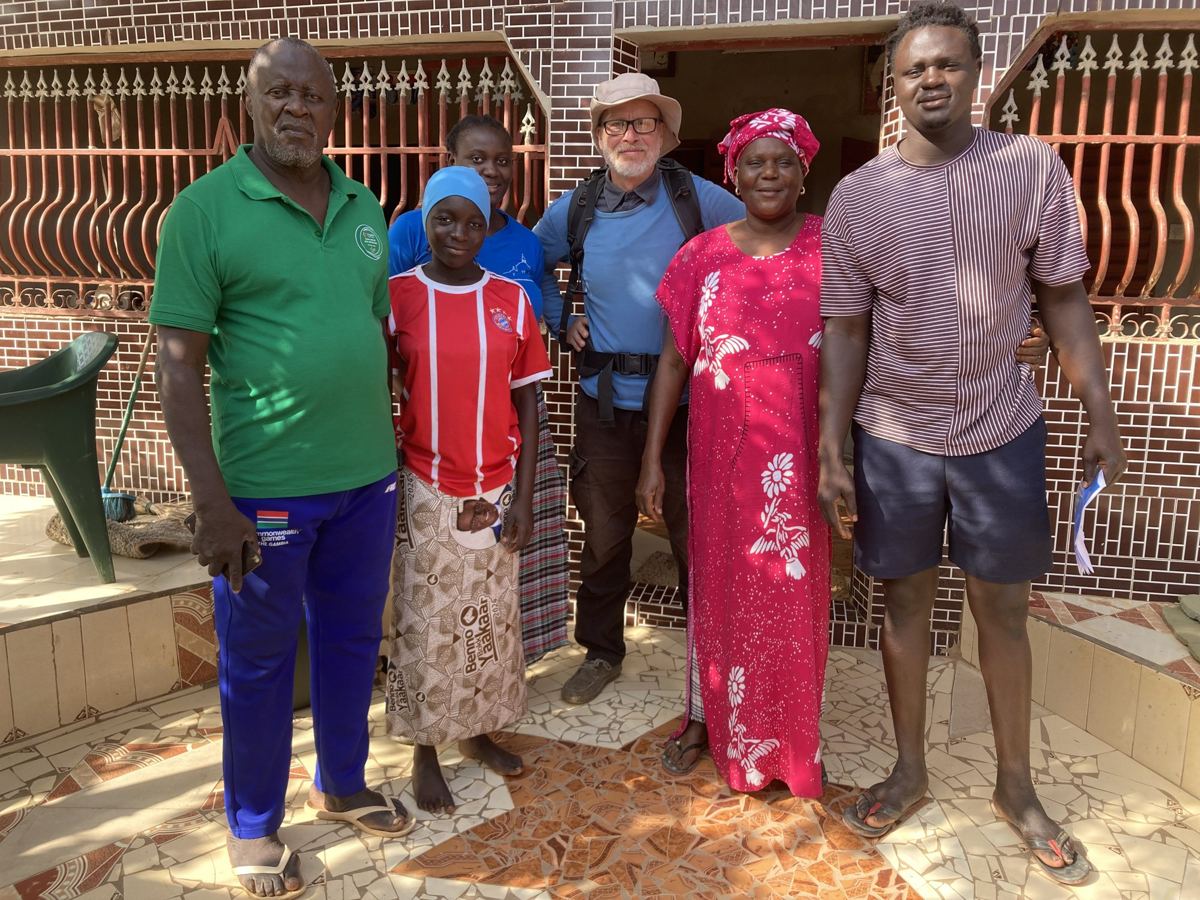 Tobias with a host family outside their house