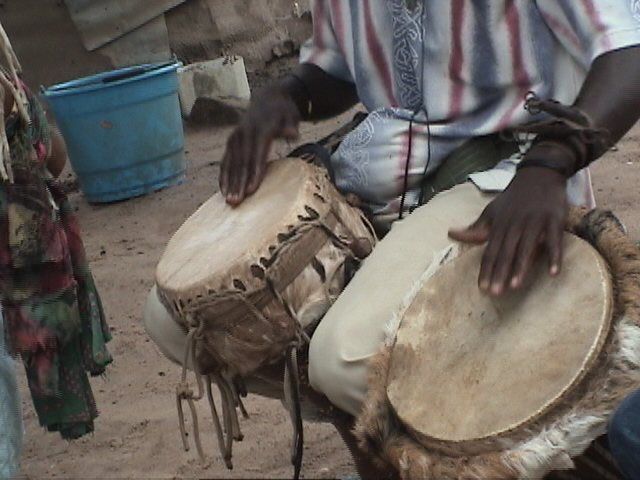 Hands on two hide-covered drums