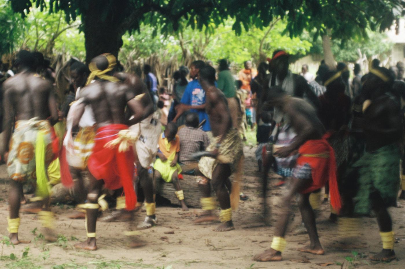 Dancers moving in a village clearing